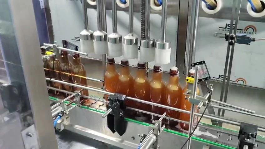 Actual video frame of the H M Pharma Machines liquid syrup filling line handling PET bottles